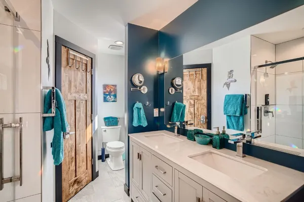 a spacious bathroom with a sink a toilet and shower