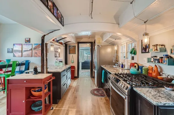 a kitchen with stainless steel appliances granite countertop a stove and a sink