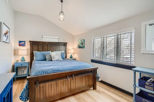 a bed room with a bed and a window