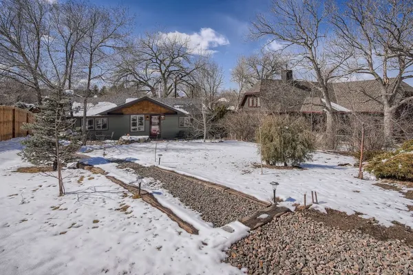 a wooden bench sitting in middle of a yard