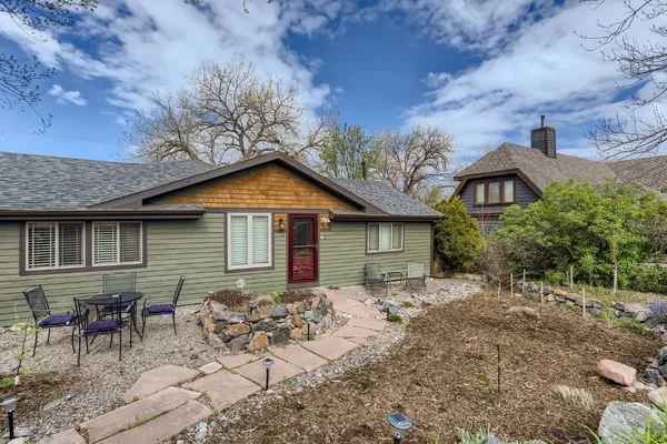a backyard of a house with table and chairs
