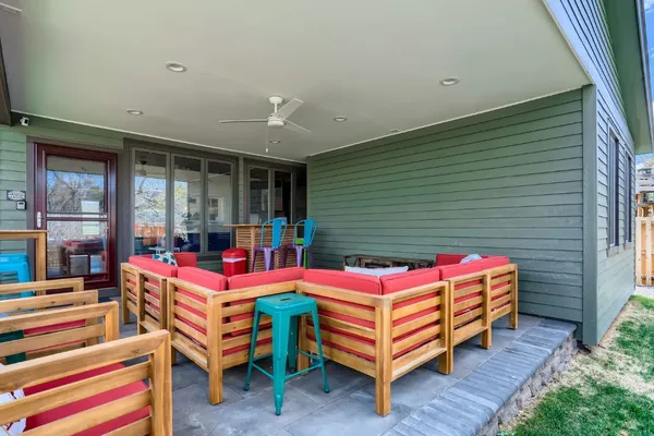 a backyard of a house with outdoor seating