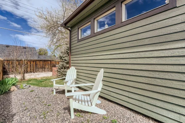 a view of a house with backyard and sitting area