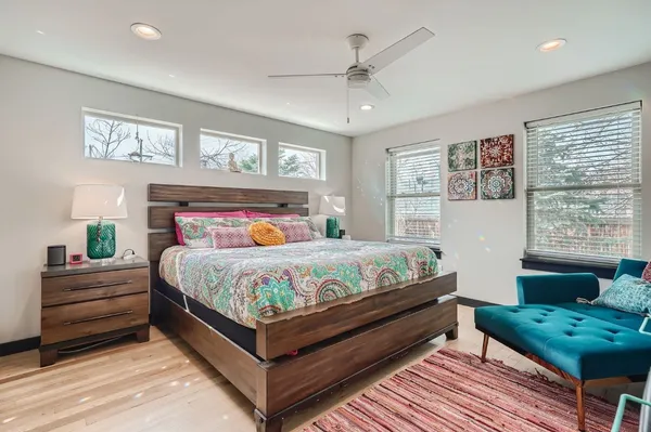 a bedroom with a bed and windows