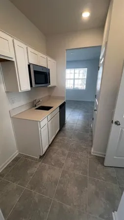 a large kitchen with kitchen island granite countertop a large counter top and stainless steel appliances