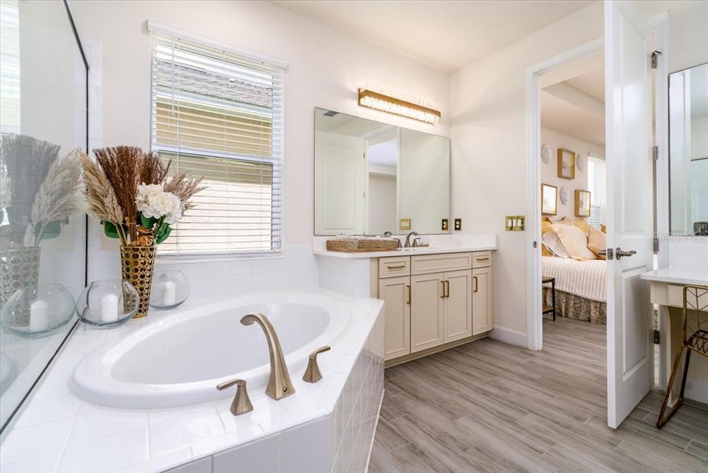 1296 Waterview Ridge Circle Apopka, FL 32703 - Photo 29 of 60 a bathroom with a double vanity sink a mirror and next to a window