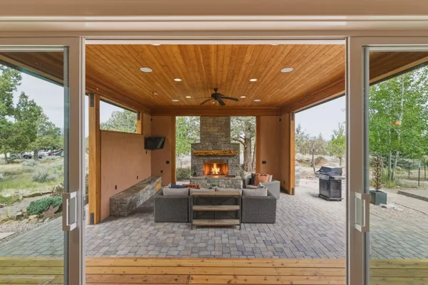 a living room with furniture and a floor to ceiling window