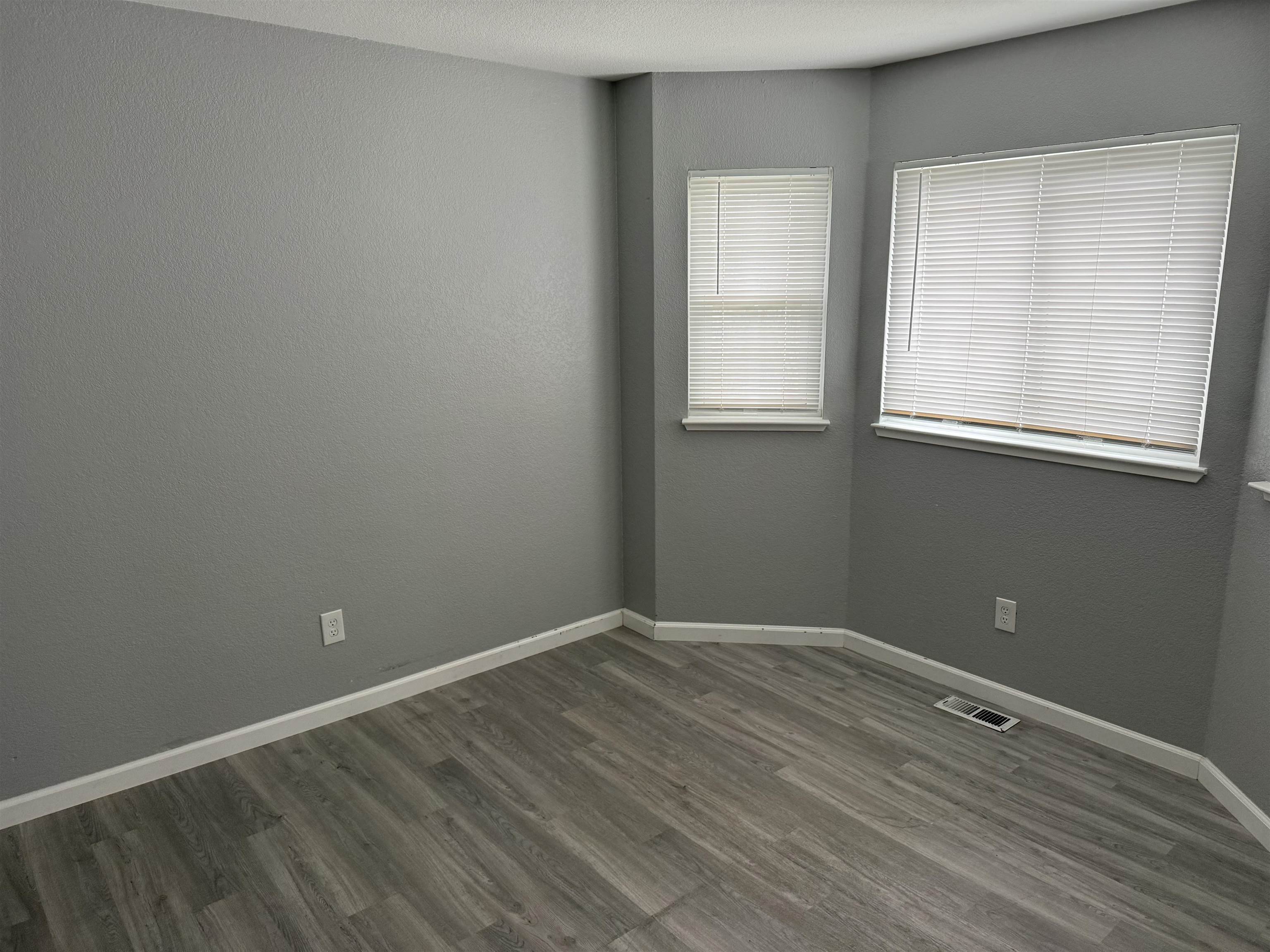 380 West Ruby Street Oakley, CA 94561 - Photo 14 of 18 an empty room with wooden floor and windows