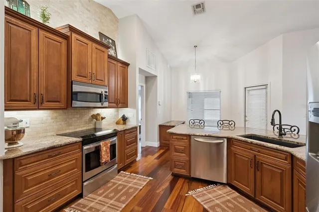 a en suite bathroom with a granite countertop sink and a mirror