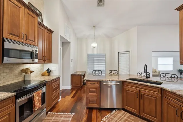 a bathroom with a granite countertop double vanity sink and a mirror