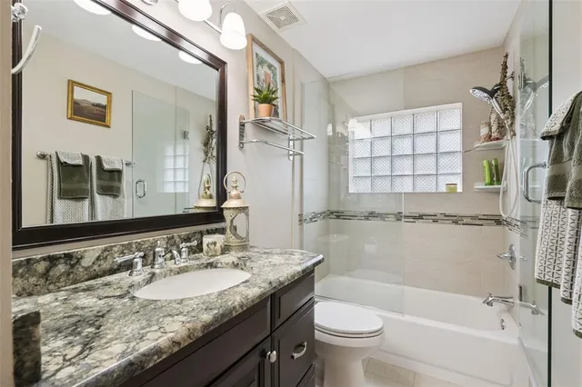 an aerial view of a house with a yard and lake view