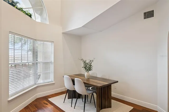 a view of a livingroom with wooden floor and a window