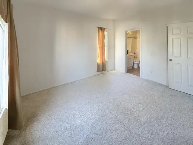 an empty room with windows and closet
