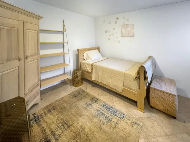 a bedroom with a bed and a cabinets