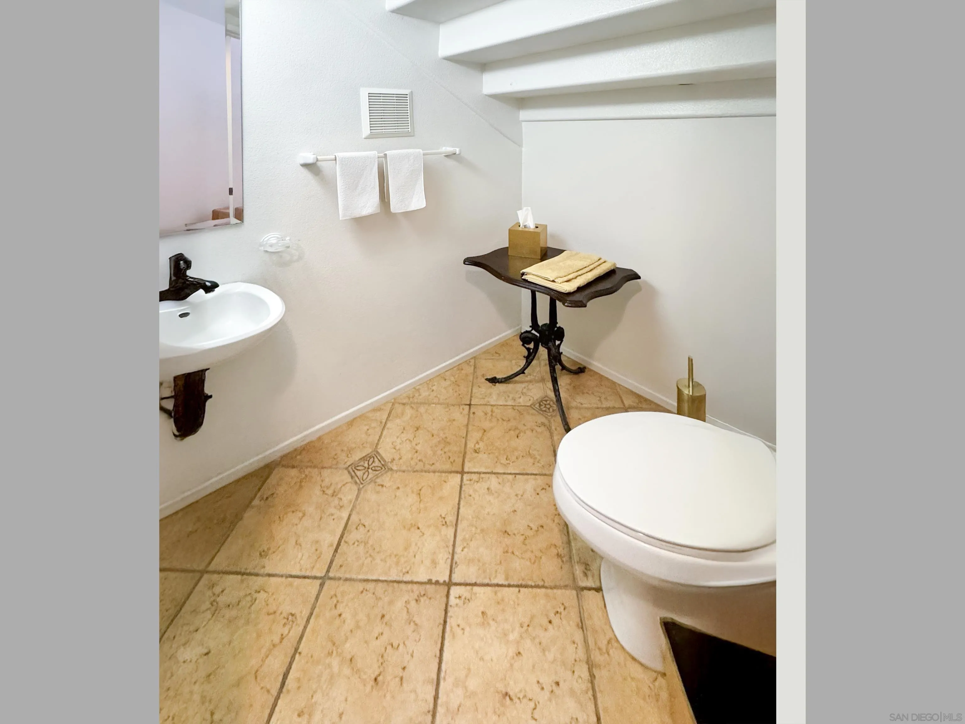 12654 Carmel Country Road, Unit 91 San Diego, CA 92130 - Photo 18 of 22 a bathroom with a sink toilet and a mirror