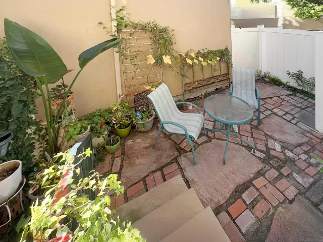 a balcony with table and chairs