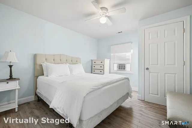 a bedroom with a large bed and a chandelier