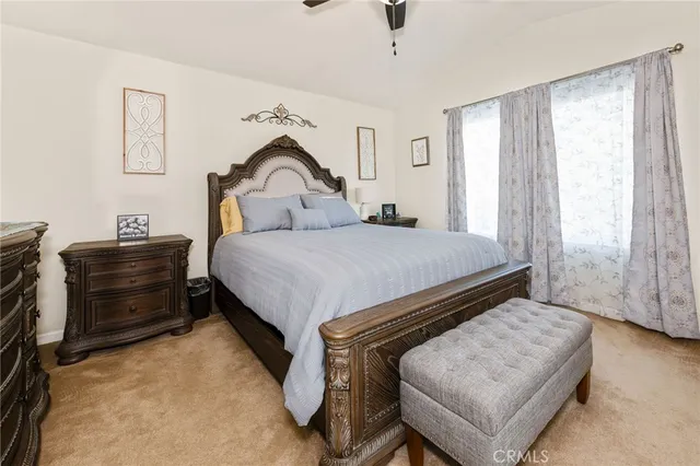 a bedroom with a bed and a dresser with wooden floor