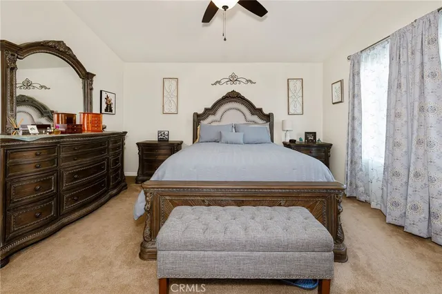 a bedroom with a bed and a large window