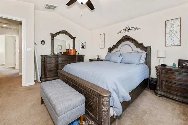 a bedroom with a bed and a dresser with mirror