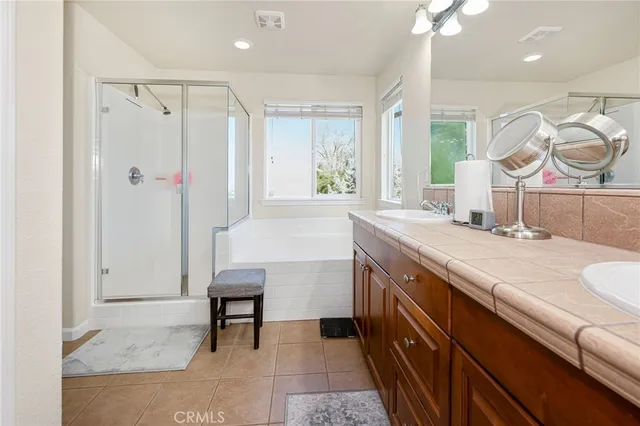 a spacious bathroom with a sink double vanity and a mirror