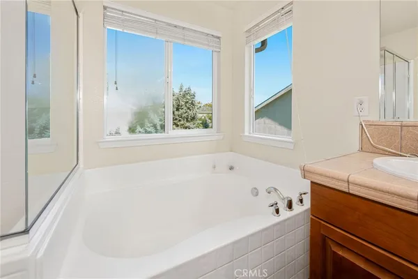 a bathroom with a bathtub and a window