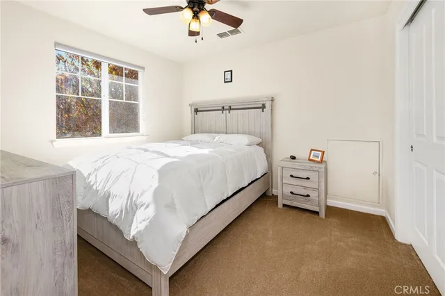a bed sitting in a bedroom next to a window