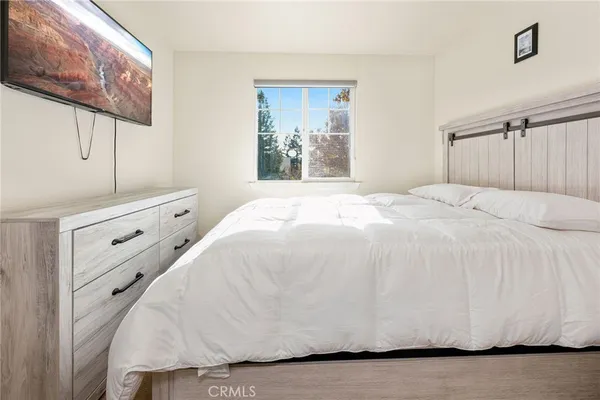 a large white bed in a white room