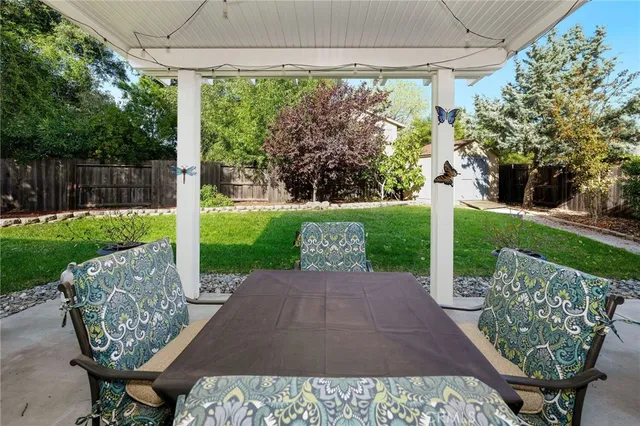 a view of a porch with furniture and garden