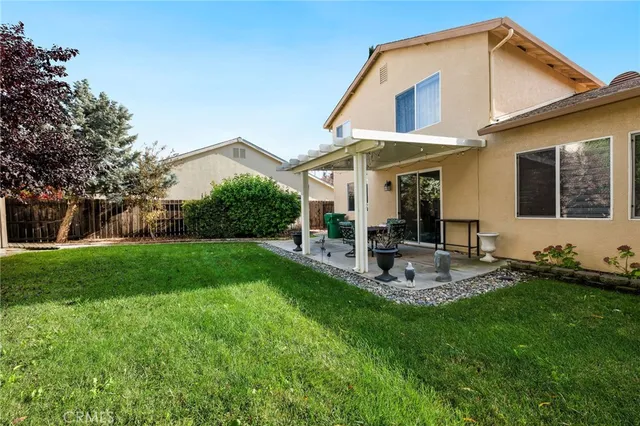 a view of a house with a yard and sitting area