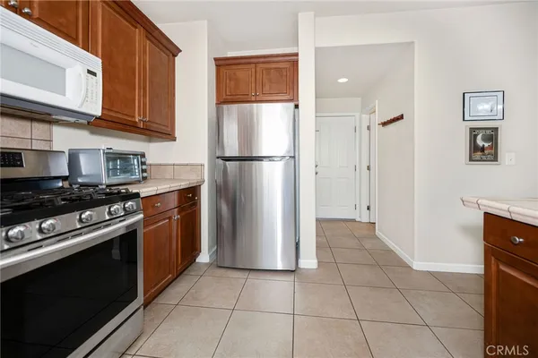 a kitchen with a stove a refrigerator and cabinets