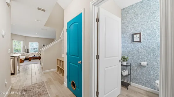a view of a hallway with windows and stairs