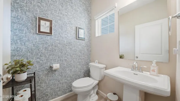 a bathroom with a sink toilet and a mirror
