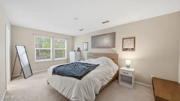 a bedroom with a bed and a chair