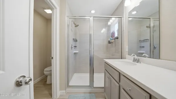 a bathroom with a shower sink and mirror