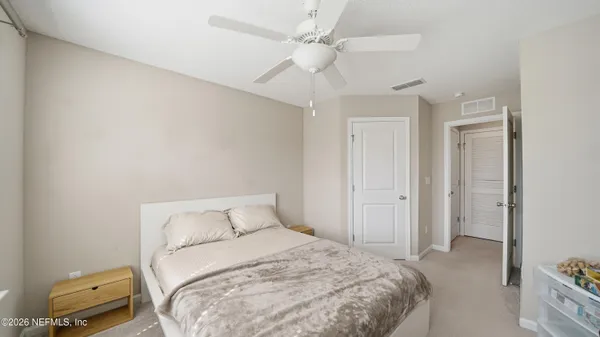 a bedroom with a bed and a tv