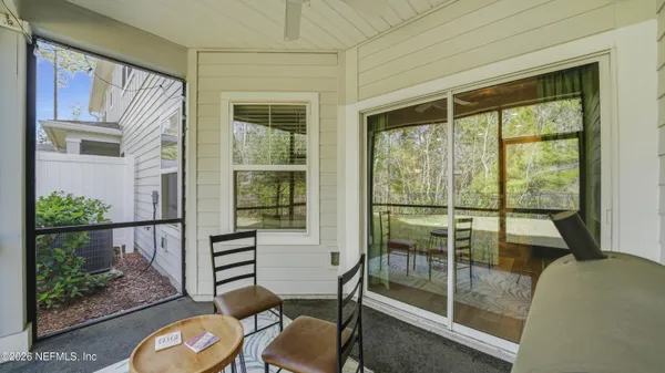 a balcony with table and chairs