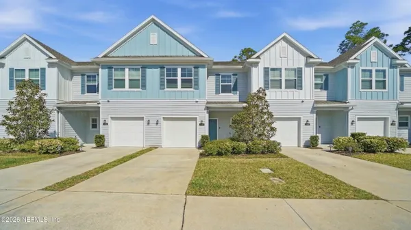 a view of a town with brick building and large tree