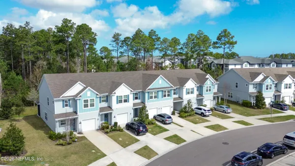 a view of multiple houses with a yard
