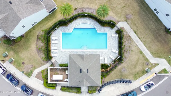 an aerial view of a house with a yard and potted plants