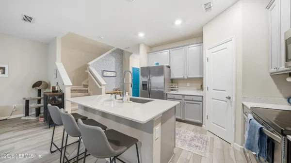 a kitchen with a table chairs stove and refrigerator