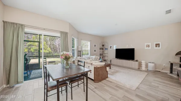 a view of a livingroom with furniture and a flat screen tv