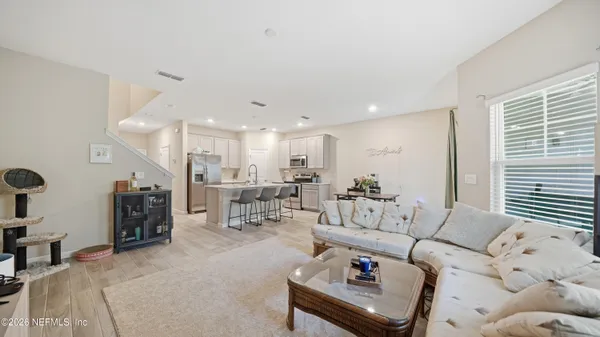 a living room with furniture and wooden floor