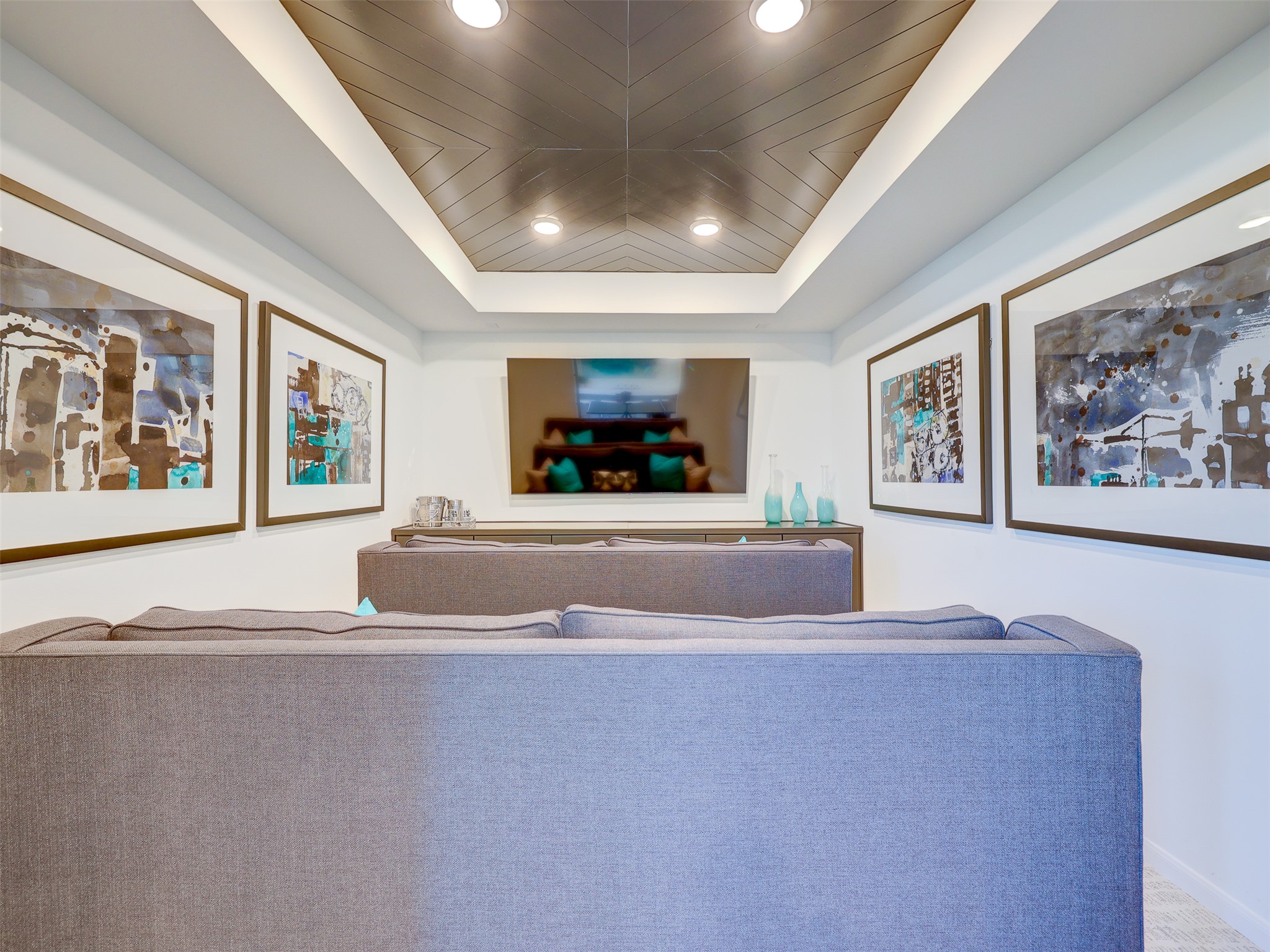 6220 Bower Well Road Austin, TX 78738 - Photo 18 of 28 An inviting media room perfect for movie nights, featuring creative ceiling design and recessed lighting.