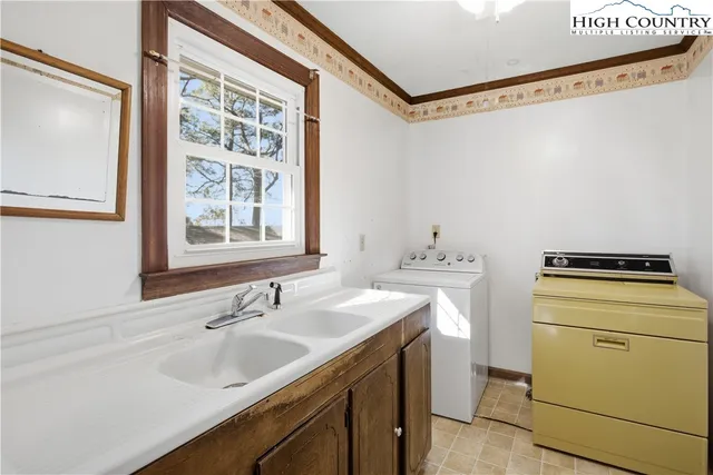 an empty room with a ceiling fan and window