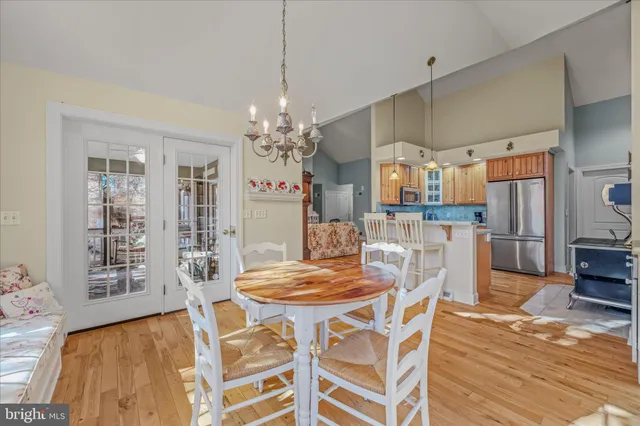 a kitchen with stainless steel appliances kitchen island granite countertop a refrigerator and a sink