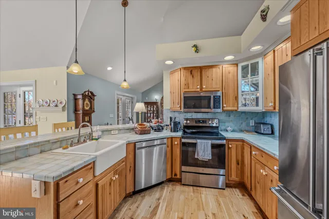 a kitchen with sink stove and cabinets