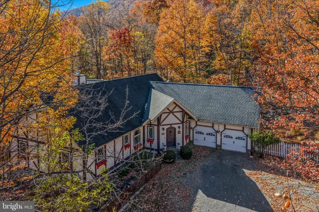 a view of a house with yard and sitting area