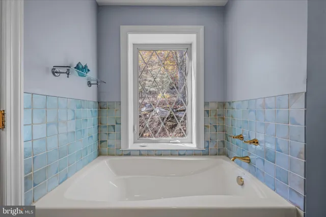 a bathroom with a bathtub and shower