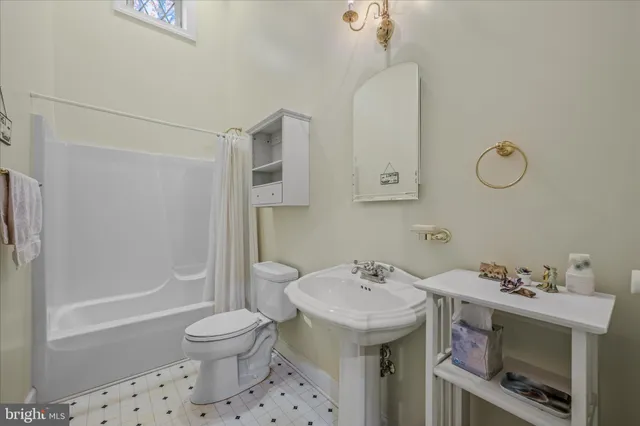 a bedroom with a bed chairs and a window